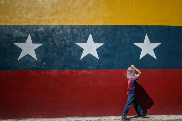 A man carrying a drum of water, Caracas, Venezuela, January 2025
